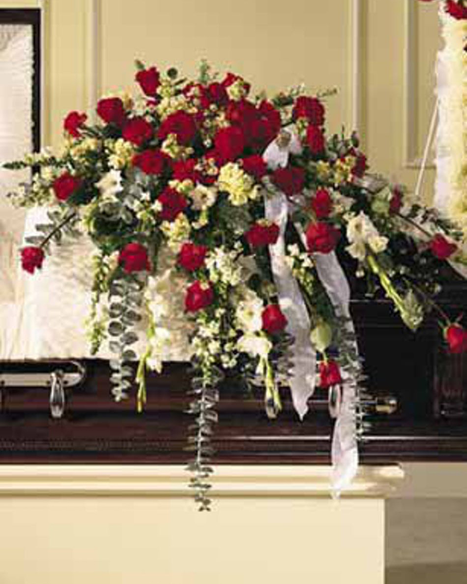 The Normandy Casket Spray The Normandy Half Casket Spray-Standard This bountiful casket saddle measures 15''x10.5'' and makes a stately and regal remembrance piece. Red and white blooms of Roses, Snapdragons, white Gladioli, red Carnations, cream Stock, white Monte Casino, baby blue Eucalyptus, and Leatherleaf give it its noble appearance. Suitable for funeral service.
DELIVERY: Every order is hand-delivered direct to the recipient. These items will be delivered by us locally, or a qualified retail local florist.