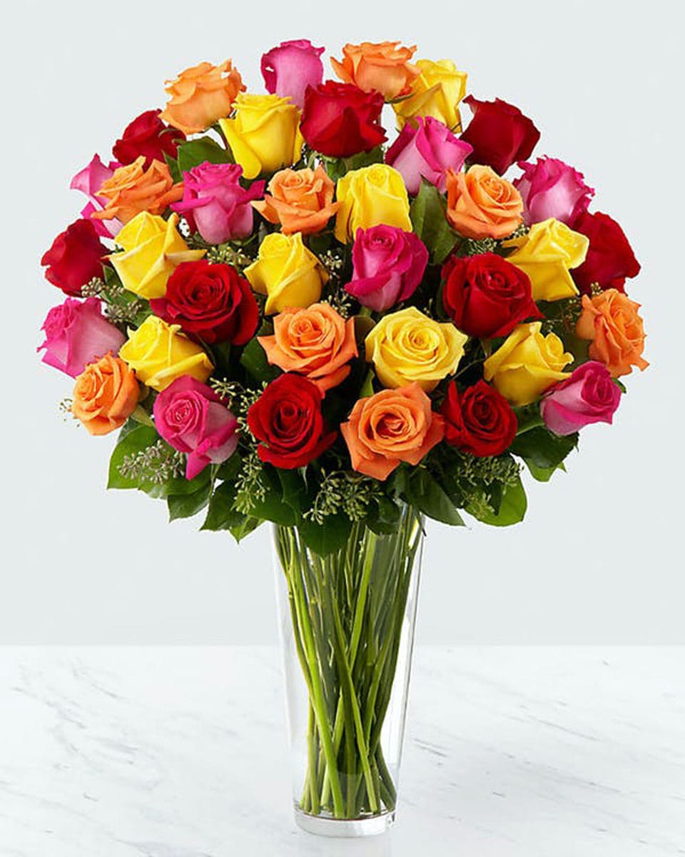 Mixed Roses arranged in a Vase 36 Mixed Roses Arranged in a Vase Gorgeous mixed color roses arranged with in a beautiful tall glass vase.
DELIVERY: Every order is hand-delivered direct to the recipient. These items will be delivered by us locally, or a qualified retail local florist.