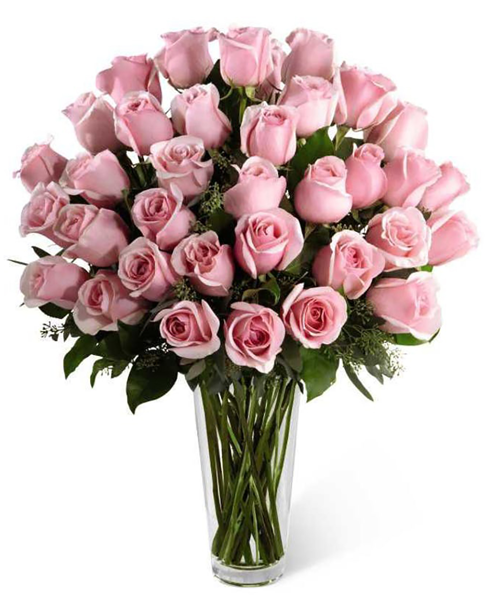 36 Pink Roses 36 Pink Roses Arranged in a Vase Beautiful, Large, Ecuadoeian  Roses are arranged in a Vase with assorted seasonal greens and fillers.
DELIVERY: Every order is hand-delivered direct to the recipient. These items will be delivered by us locally, or a qualified retail local florist.
