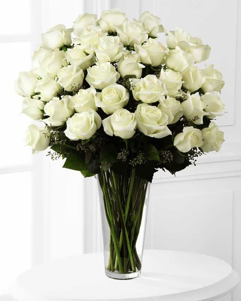 24 White Roses Deluxe-36 White Roses 24 Long Stem White Roses arranged in a Vase with assorted greens and fillers.
DELIVERY: Every order is hand-delivered direct to the recipient. These items will be delivered by us locally, or a qualified retail local florist.