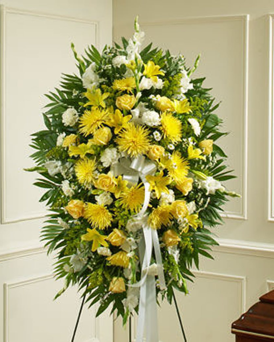 The Toledo Standard A Standing Spray consisting of Spider Mums, Carnations, Roses, Gladioulus, Snapdragons, and Commadore in a yellow and white color scheme. 
DELIVERY: Every order is hand-delivered direct to the recipient. These items will be delivered by us locally, or a qualified retail local florist.