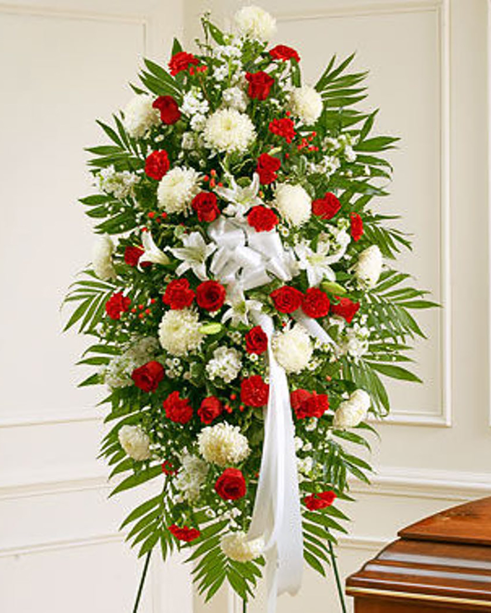 The Mountaintop Standard Standing spray consisting of white China Mums, White Lillies, and lots of Red Roses.
DELIVERY: Every order is hand-delivered direct to the recipient. These items will be delivered by us locally, or a qualified retail local florist.