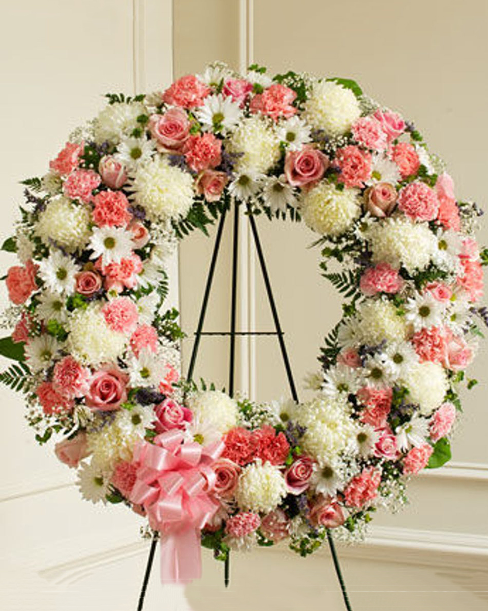 Serene Blessings Standard (18 Inch) Standing Wreath on an easel consisting of White China Mums, White Daisy Mums, Pink roses, Pink Carnations, Babys Breath, and assorted Greens.
DELIVERY: Every order is hand-delivered direct to the recipient. These items will be delivered by us locally, or a qualified retail local florist.