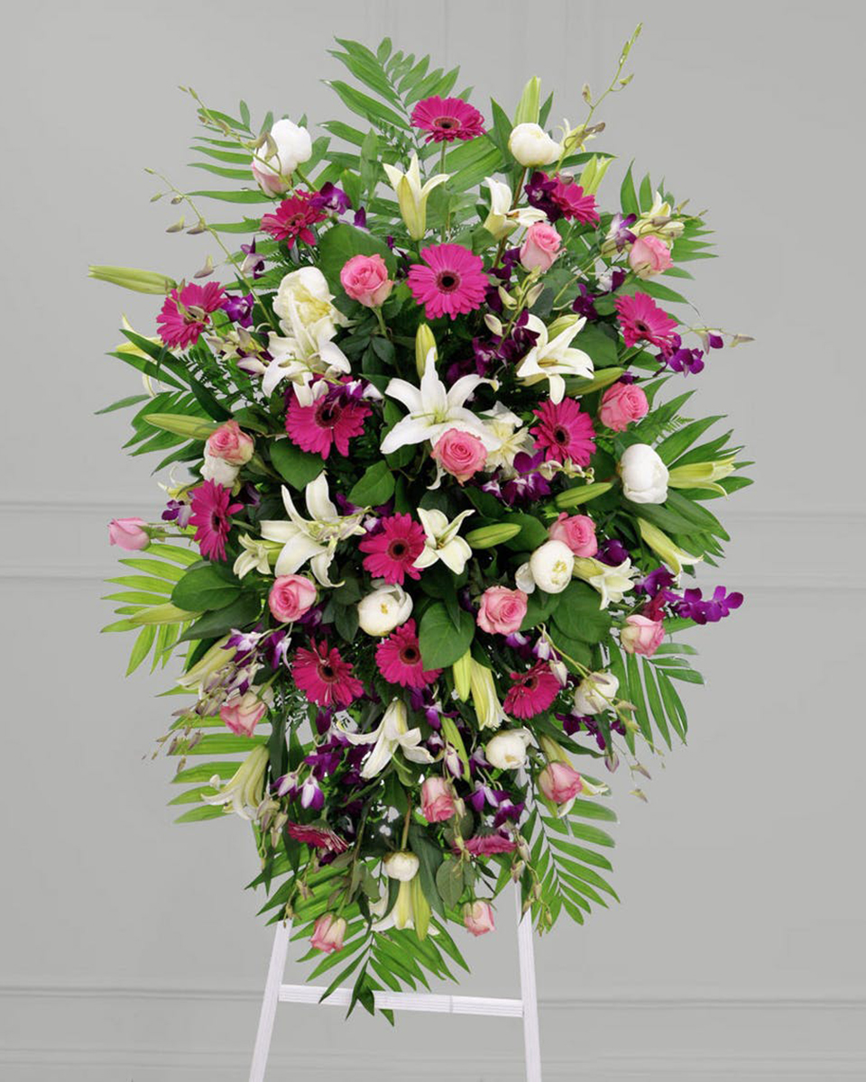 Pastel Passion Standard A Standing Spray consisting of Pink Roses, Dark Pink Gerbera Daisies, White Lillies, Bombay Dendrobium Orchids, White Peony, Commadore , and Lemon Leaf. The Spray rests on a 5 foot easel.
DELIVERY: Every order is hand-delivered direct to the recipient. These items will be delivered by us locally, or a qualified retail local florist.