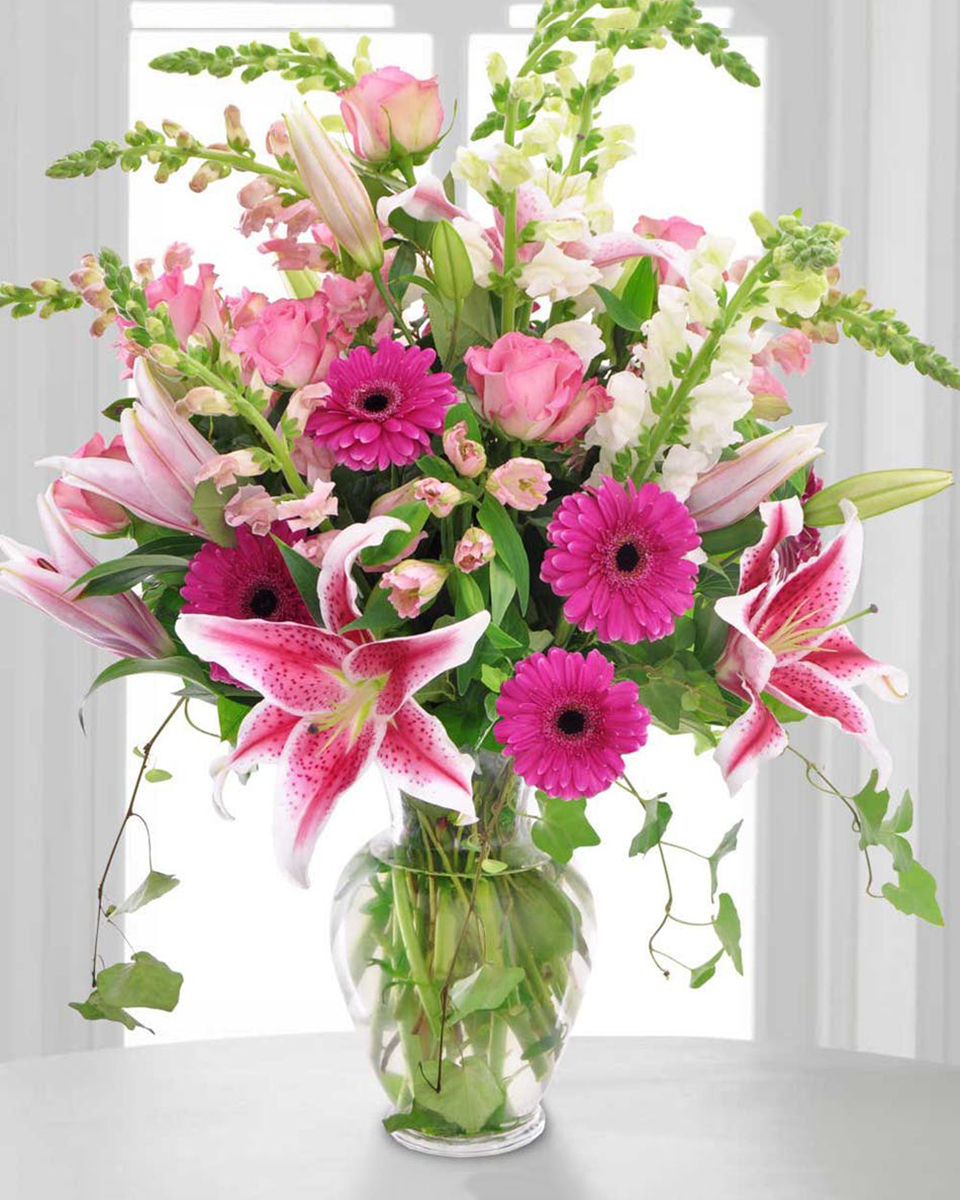 Pink Passion Standard Snapdragons, Gerbera Daisies, Mini Carntions, Roses, and Stargazer Lillies in Assorted Shades of Pink arranged in Glass Urn.
DELIVERY: Every order is hand-delivered direct to the recipient. These items will be delivered by us locally, or a qualified retail local florist.