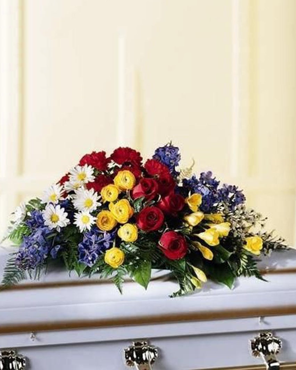Eternal Slumber Casket Spray Eternal Slumber Casket Spray Half Casket Spray-Standard Rows of brightly colored flowers such as roses, ranunculus, daisies, alstroemeria and more, make a bold and vibrant display. To be displayed on a casket.
DELIVERY: Every order is hand-delivered direct to the recipient. These items will be delivered by us locally, or a qualified retail local florist.