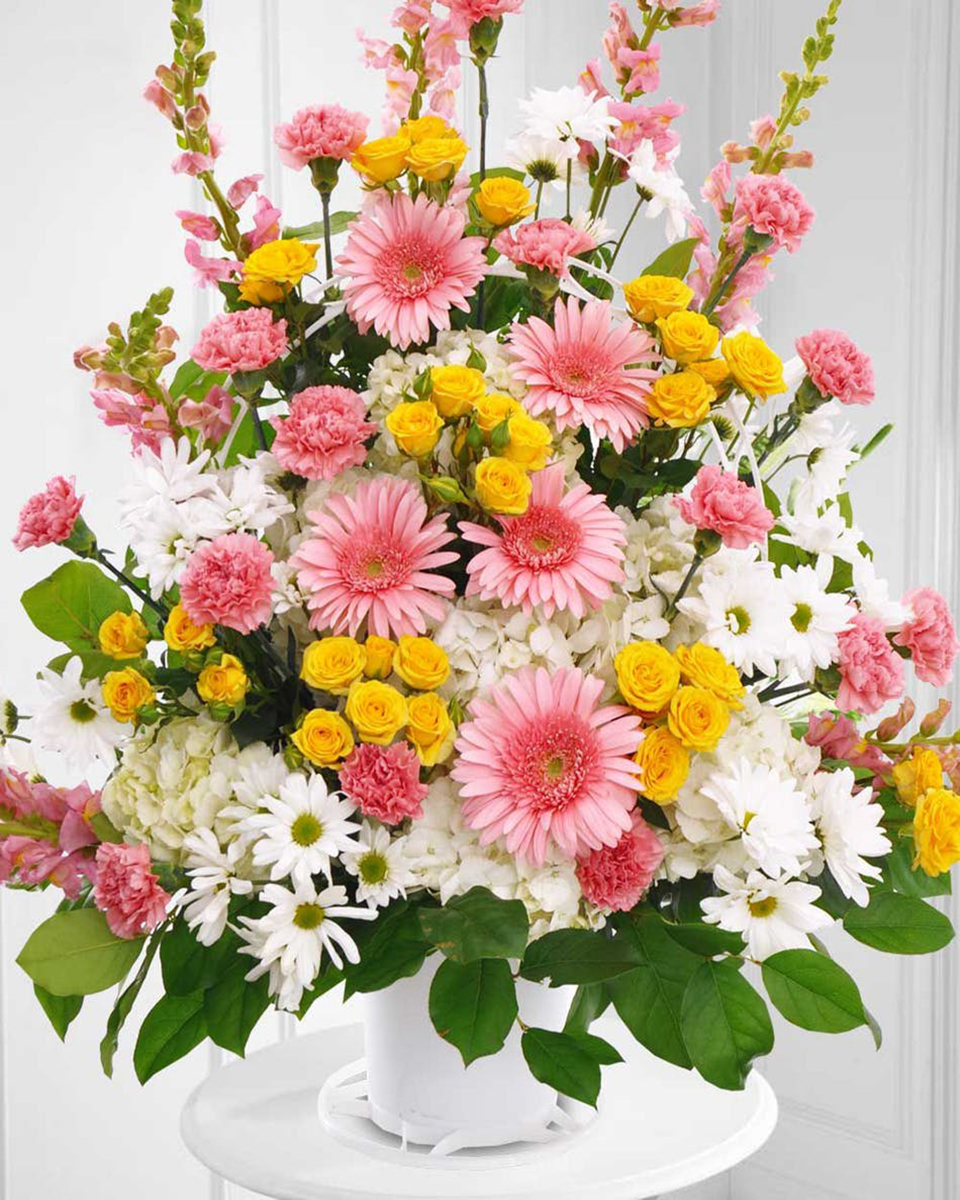 Reflections Standard A one sided Sympathy Basket Arrangement is composed of Pink Snapdragons, Pink Larkspur, Pink Carnations, Pink Gerbera Daisies, White Daisy Poms, White Hydrangea, Yellow Spray Roses, and Lemon Leaf.
DELIVERY: Every order is hand-delivered direct to the recipient. These items will be delivered by us locally, or a qualified retail local florist.