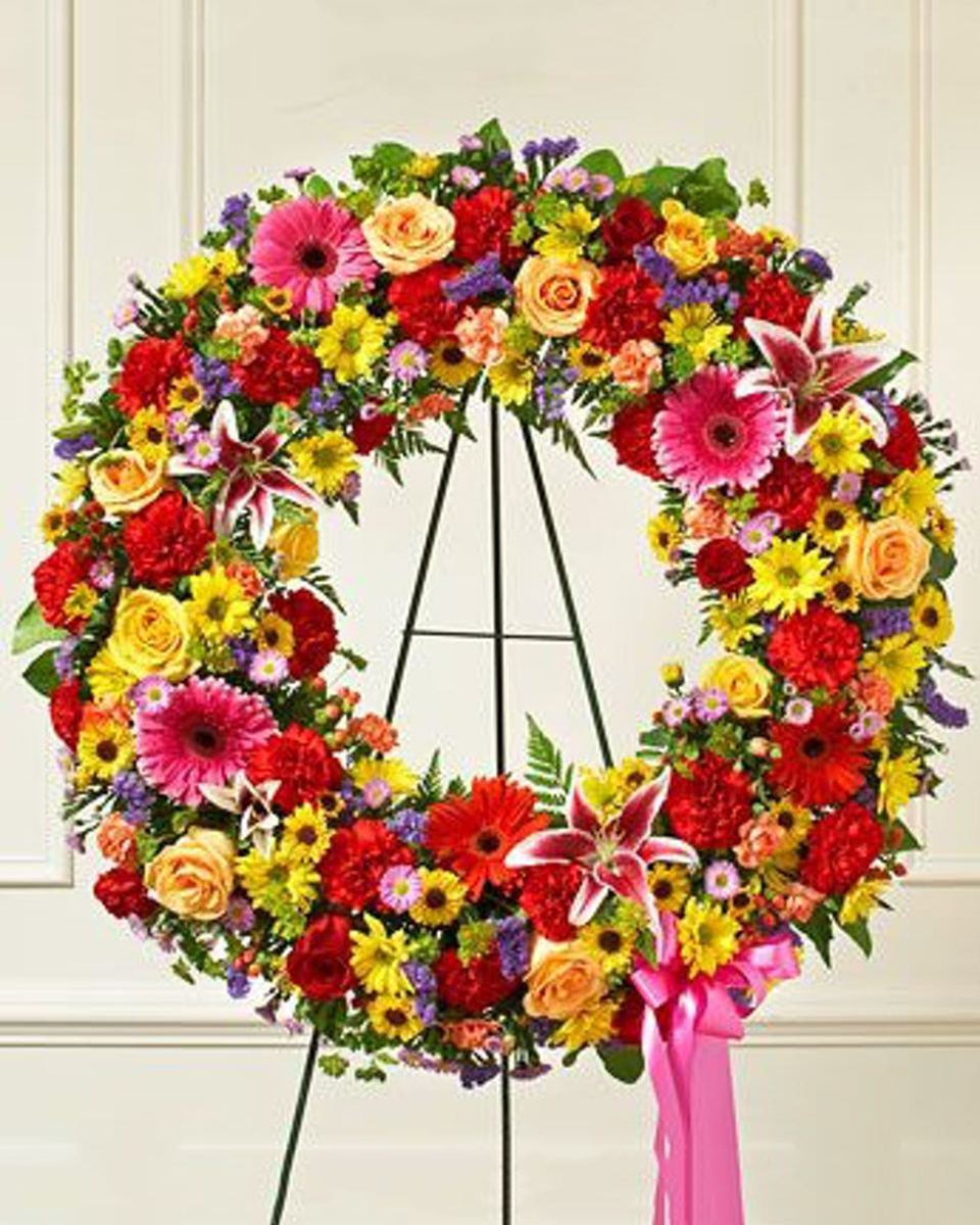 Colores Brilliante Wreath Deluxe (24 Inch) Beautiful, a standing wreath offers comfort and tribute at a difficult time. Featuring a brilliant mix of bright roses, lilies, gerbera daisies and much more.*DELIVERY: Every order is hand-delivered direct to the recipient. These items will be delivered by us locally, or a qualified retail local florist.