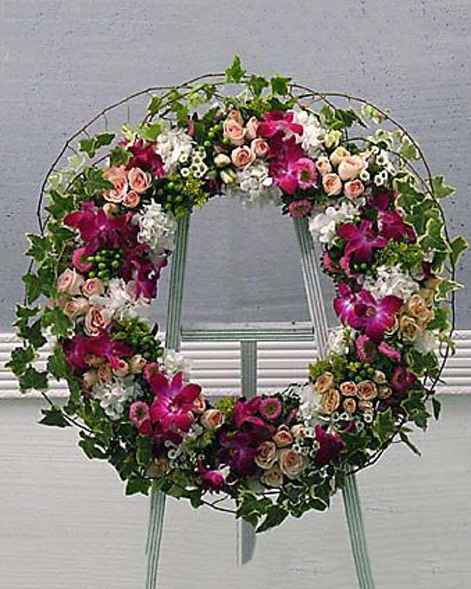 Eternity Wreath Standard (18 Inch) Express your condolences with an adorning wreath. This design is clustered together with pink spray roses, white hydrangea blooms and tropical orchids accented with variegated ivy. This classic design offers a respectful, beautiful remembrance that family and friends will certainly appreciate.
DELIVERY: Every order is hand-delivered direct to the recipient. These items will be delivered by us locally, or a qualified retail local florist.