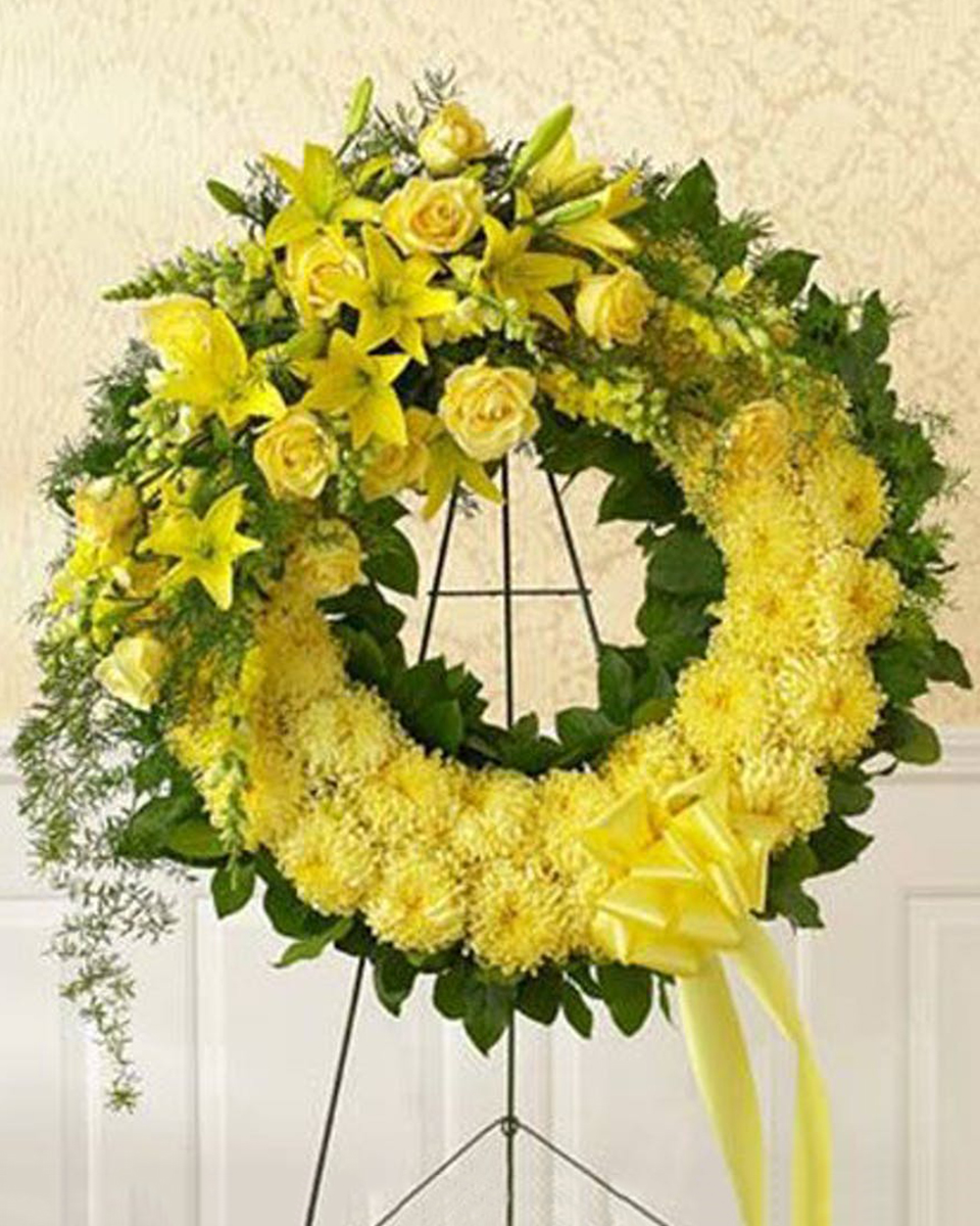 Ring of the Spirit Standard (18 Inch) This stunning wreath is a perfect symbol of love, sympathy and support.* Single-colored flowers such as mums, snapdragons and lilies are accented with monte casino, springeri and salal.
NOTE: * Available in yellow, pink or white. 
DELIVERY: Every order is hand-delivered direct to the recipient. These items will be delivered by us locally, or a qualified retail local florist.