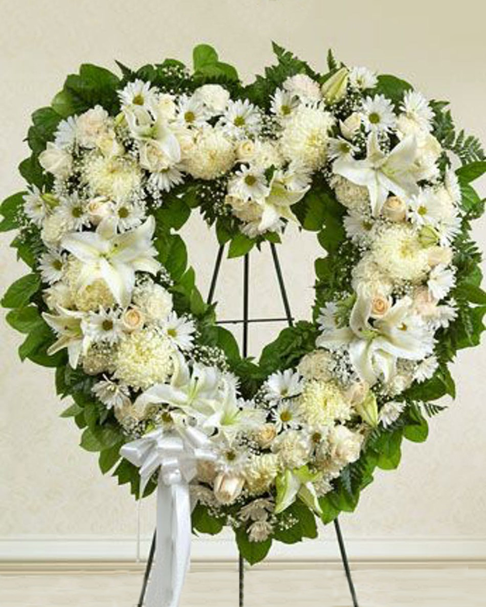 WhiteHeart WhiteHeart-Standard (18 Inch) This elegant wreath is crafted using a variety of white flowers. The open-heart shaped design is featured as a standing display.
DELIVERY: Every order is hand-delivered direct to the recipient. These items will be delivered by us locally, or a qualified retail local florist.