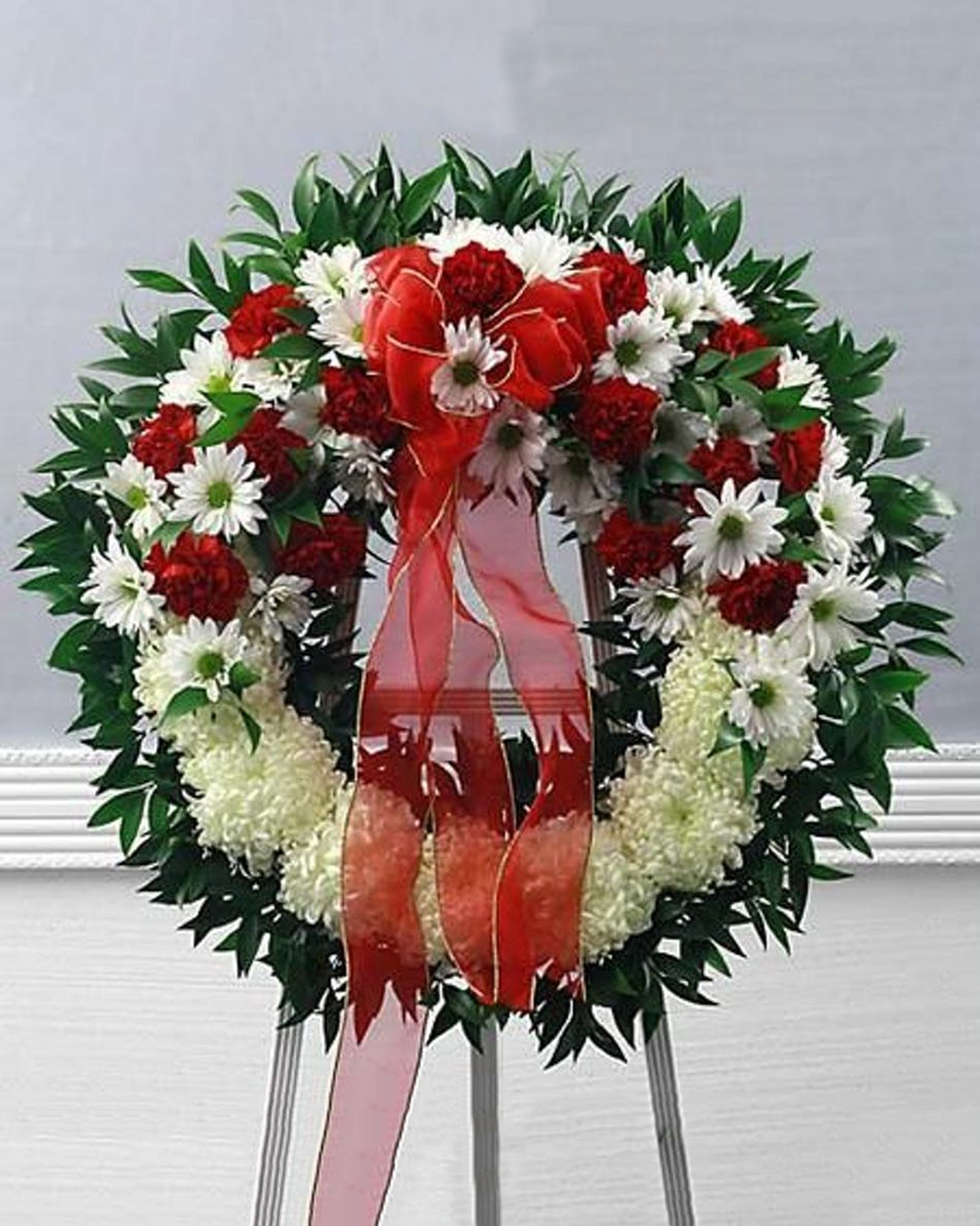 Royal Tribute Standard (18 Inch) Red and white flowers nestled together to form this elegant wreath. This arrangement will allow you to express your deepest sympathies to family and loved ones.
DELIVERY: Every order is hand-delivered direct to the recipient. These items will be delivered by us locally, or a qualified retail local florist.