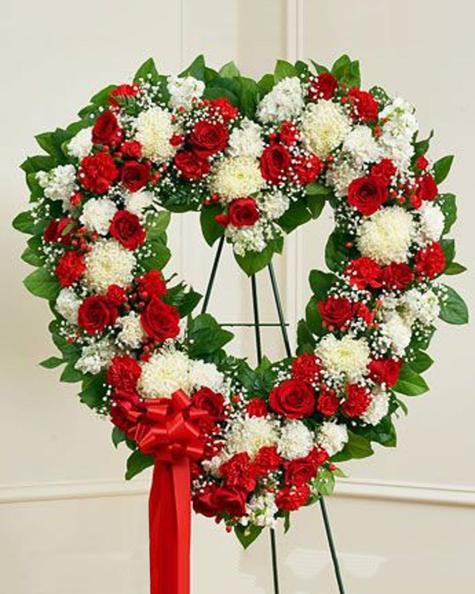 King of the Heart Standard (18 Inch) This standing open heart designed features a beautiful red and white mix such as roses, mums, mini carnations and more.
DELIVERY: Every order is hand-delivered direct to the recipient. These items will be delivered by us locally, or a qualified retail local florist.