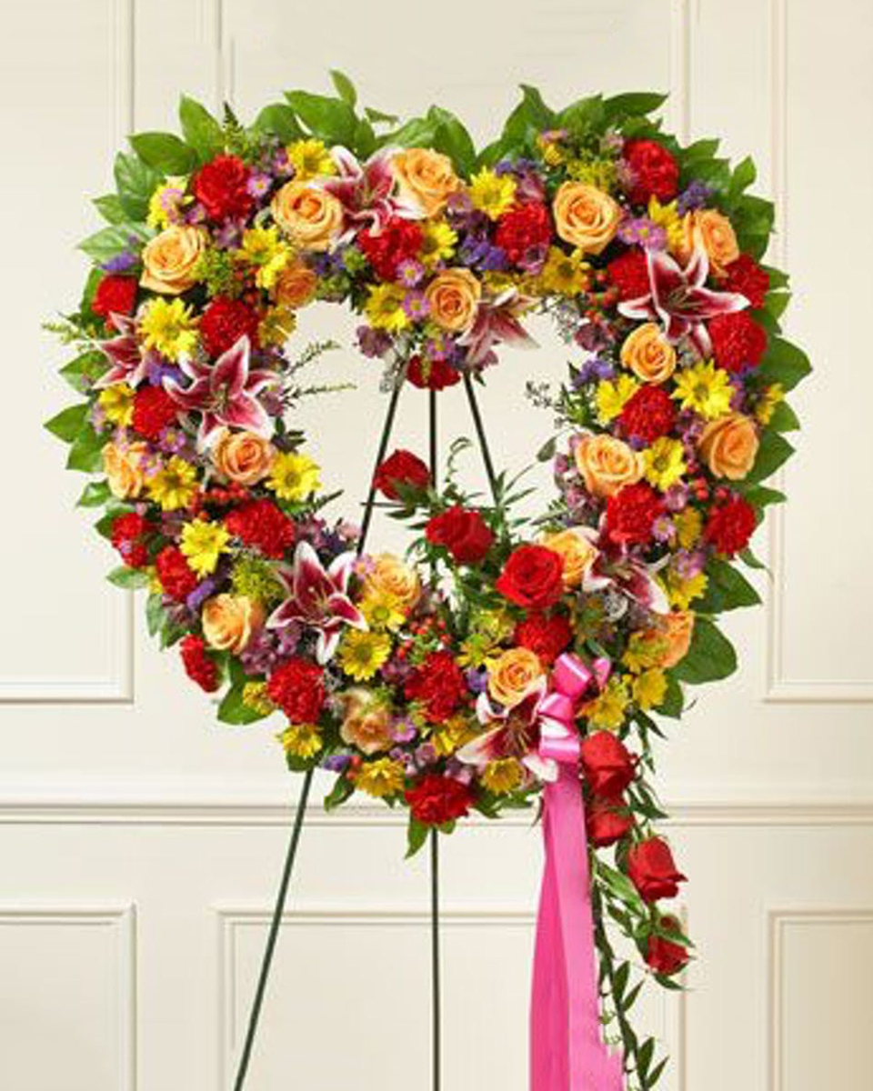 Summers Garden Open Heart Deluxe (24 Inch) Summer flowers such as roses, alstromeria and more combine to create a brilliant sympathy design. The open heart wreath is a popular expression of sympathy.
DELIVERY: Every order is hand-delivered direct to the recipient. These items will be delivered by us locally, or a qualified retail local florist.