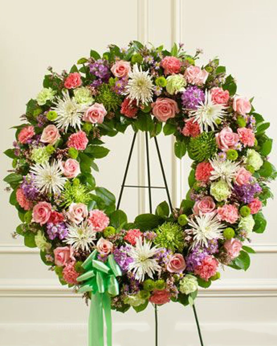 Spring Garden Wreath Standard (18 Inch) This elegant standing wreath features beautiful pastel tones created from garden florals. The is wonderful way to express your sympathy.*Large arrangement measures approximately 34