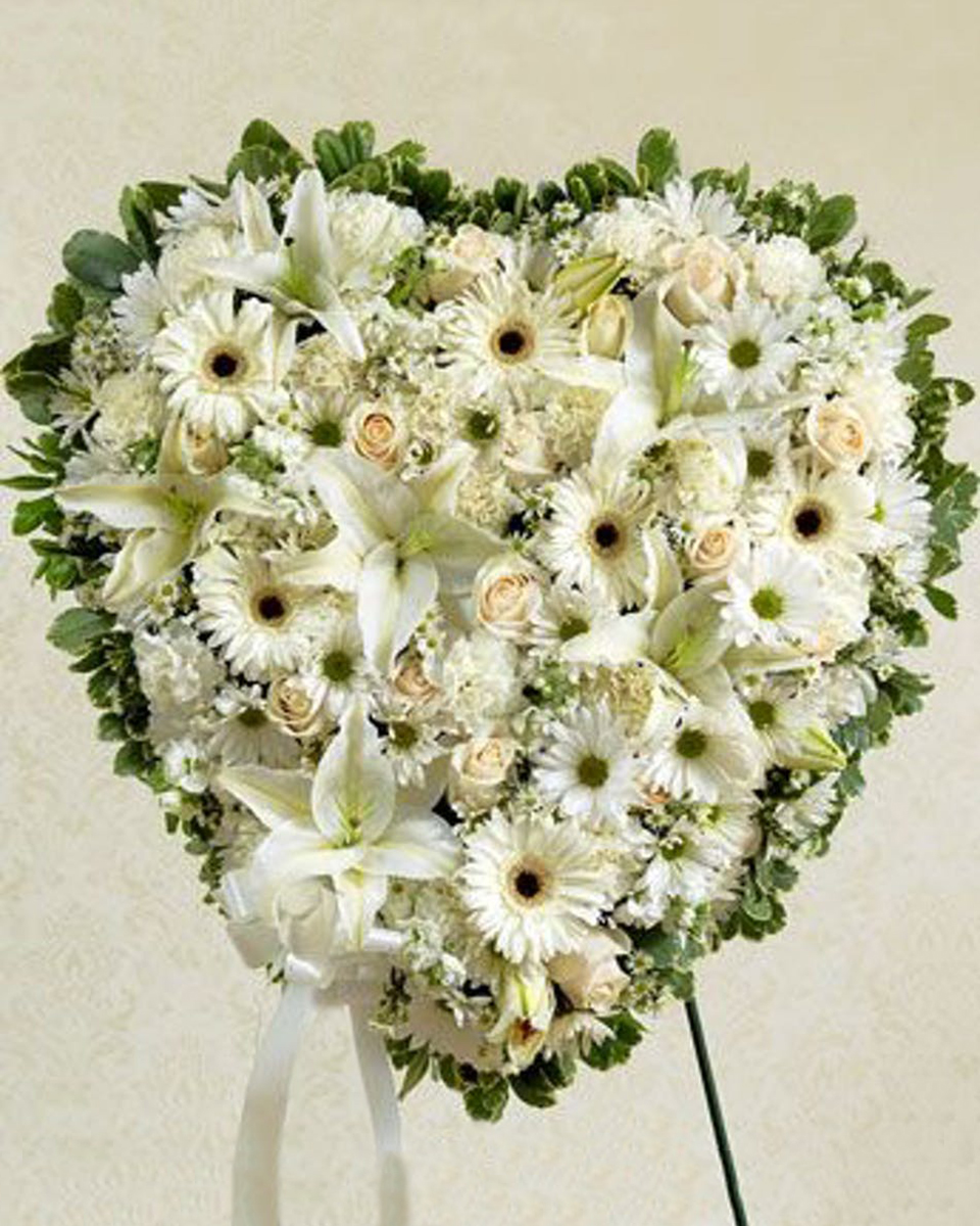 Heartful Expressions Standard (18 Inch) Elegant solid white heart standing design is perfect for sharing your sympathy with your loved ones. This design features a variety of white garden flowers.
DELIVERY: Every order is hand-delivered direct to the recipient. These items will be delivered by us locally, or a qualified retail local florist.
