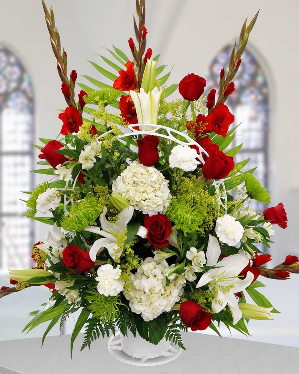 Pastoral Green Meadows Standard Vibrant green spider mums,  red gladiolus, red roses, white hydrangea, white carnations, white crystal blanca lilies, solidago, and complimentary greens are elegantly designed in a forever lasting handled sympathy basket.
DELIVERY: Every order is hand-delivered direct to the recipient. These items will be delivered by us locally, or a qualified retail local florist.