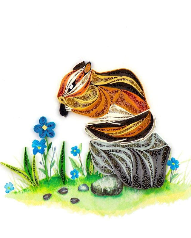 Thanksgiving Chipmunk Quilling Card A quilled chipmunk greeting card makes an adorable gift for any occasion. A chipmunk represents harmony with nature and a balanced life making this a great card to gift a friend who need to reconnect with nature and balane our their life. The design features a handcrafted chipmunk in browns and oranges nibbling on seeds while perched on a gray rock surrounded by blue flowers.
Don’t just send a card, send art!
