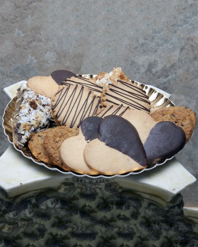 Chocolate is the Answer Cookie Assortment These Cookies are for the Chocolate Lover in all of us. Chocolate Dipped Heart Cookies, Chocolate Chip Cookies, Almond Biscotti, Coconut Bars, Chocolate Chip Bars, Walnut Bars, and Chocolate-Ganache filled Butter Cookies come in this tantalizing assortment. These Cookies are daily baked in Long Beach to ensure Freshness and quality.
DELIVERY: Every order is hand-delivered direct to the recipient. These items will be delivered by us locally, or a qualified retail local florist.