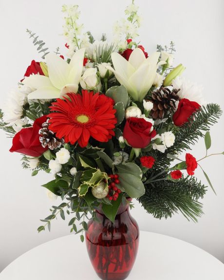 Christmas Love-Christmas Love - Red roses,gerberas. white spay roses, mini carnations are exquisitely arranged with white asiatic lilies and chrysanthemums in a ruby red glass vase. -Christmacs Flowers