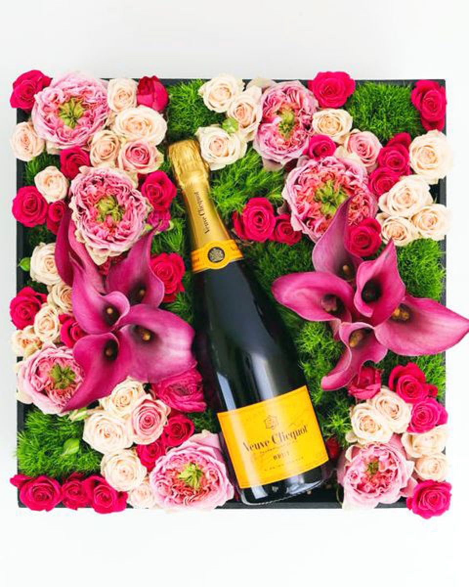 Flower Fields Forever Crate  With Veuve Clicquot Champagne  A huge flower garden of assorted lilies, roses, and green ball dianthus, is synergized with a wine or champagne of your choice and then crafted in a rustic wood crate.  Approximately 16 inches by 16 inches.
DELIVERY: Every order is hand-delivered direct to the recipient. This item is only deliverable to local areas serviced by the Allen’s Flower Market chain and its affiliates.