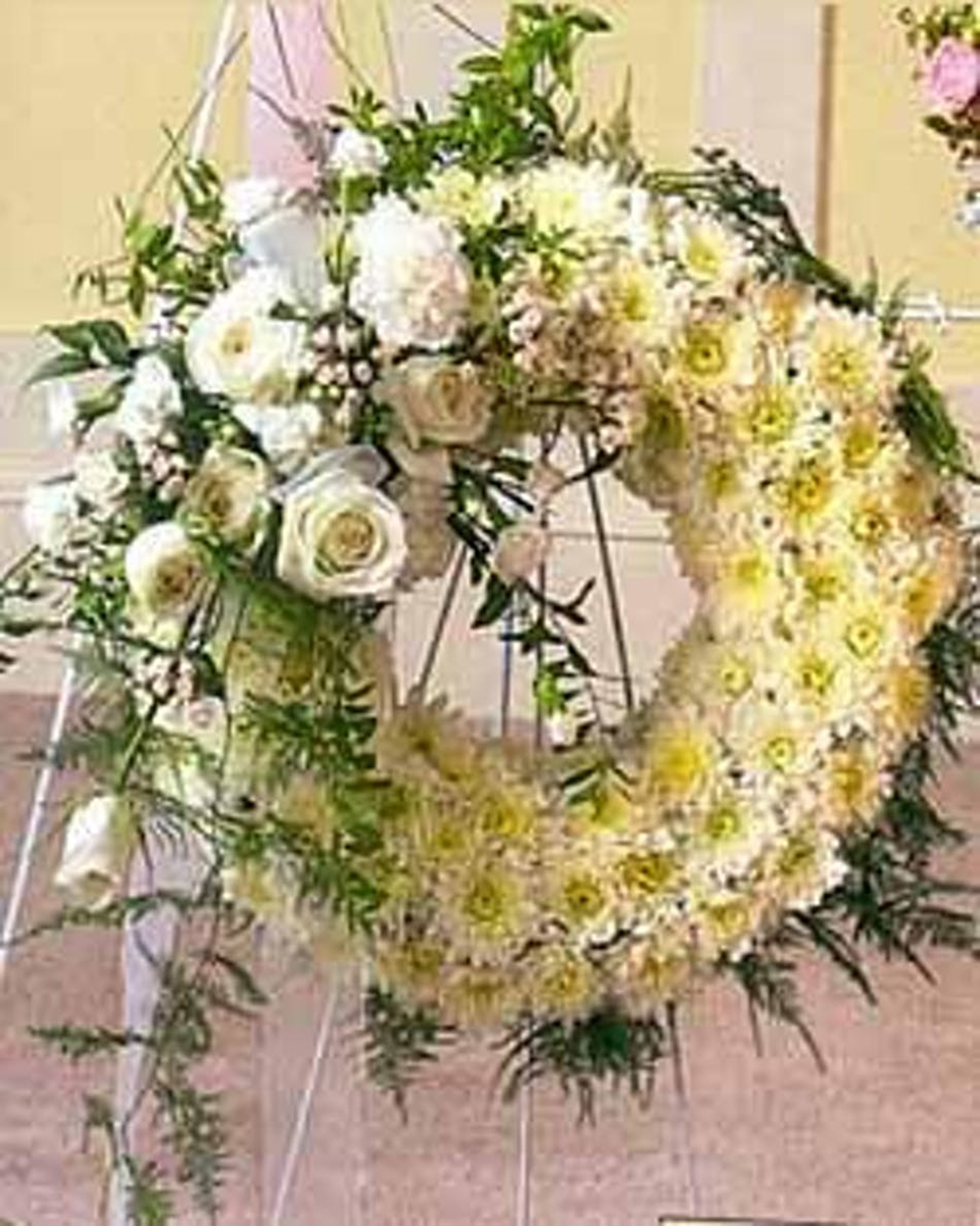 Pure White Beauty Standard (18 Inch) Remember a loved one with the purity and innocence of white blossoms that adorn this standing wreath arrangement. A profound statement of beauty and grace, to fully show what your heart really says, even with the absence of words.
DELIVERY: Every order is hand-delivered direct to the recipient. These items will be delivered by us locally, or a qualified retail local florist.