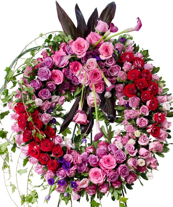 Garden Elegance Wreath Standard-24 Inches A radiant, multicolored wreath using the finest garden flowers is a tribute to the spirit of those passed.  Arrangement includes roses, orchids, calla lilies hydrangea and other assorted garden flowers in shades of purple, pink and green.  Deluxe size shown.
DELIVERY: Every order is hand-delivered direct to the recipient. These items will be delivered by us locally, or a qualified, retail, local florist.
