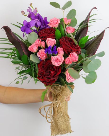 Garden Enchantment-Featuring a stunning combination of unique flowers, lush greens, and unique textures, this hand-tied bouquet is delivered in a water-retaining floral swaddle, wrapped in burlap, and ready to drop in a vase!-hand bouquet