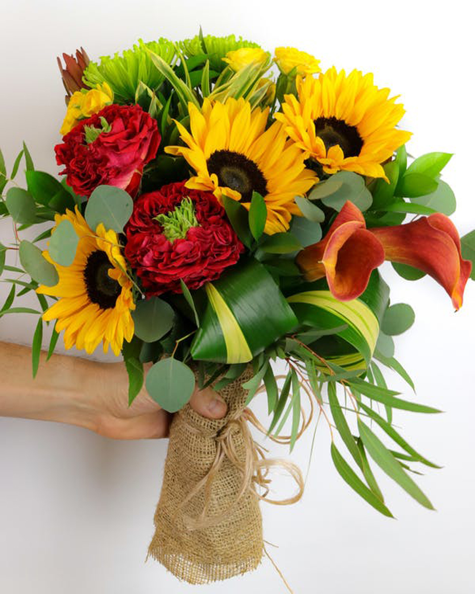 Garden Sun ( Hand Tied Bouquet) Standard Featuring a stunning combination of unique flowers, lush greens, and unique textures, this hand-tied bouquet is delivered in a water-retaining floral swaddle, wrapped in burlap, and ready to drop in a vase!
DELIVERY: Every order is hand-delivered direct to the recipient. This item is only deliverable to local areas serviced by Allen’s Flower Market Stores. 
