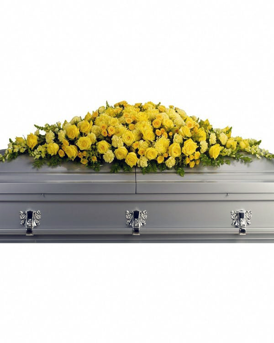 Golden Grace Casket Spray Standard Sunny yellow roses, spray roses, carnations, chrysanthemums, snapdragons and more are arranged in a dazzling full casket spray. Approximately 64