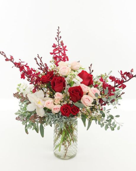 Heart and Soul-This best-selling arrangement features red roses, pink spray roses, white stock, unique Red Elephant orchids and loads of seasonal textures presented in a designer glass spin In a clear glass cylinder.
v day arrangement