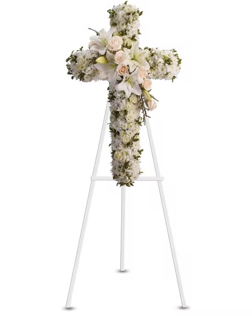 Heavenly Light Deluxe-24 inch Crème roses, white spray roses, oriental lilies, stock, leptosporum, cushion and button spray chrysanthemums create a cross that is a beautiful way to honor a loved one.