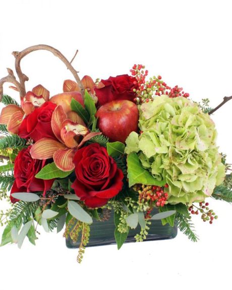 Honey and spice-Beautiful hydrangea, red roses, and cymbidium orchids are designed with seasonal accents.- christmas centerpieces
