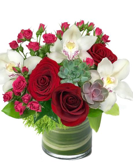 HOT STUFF-A beautiful, colorful Tea Pot keepsake is adorned with Roses, Spray Roses, and Cymbidium Orchids. The perfect Mothers Day Gift. -CUBE ARRANGEMENT