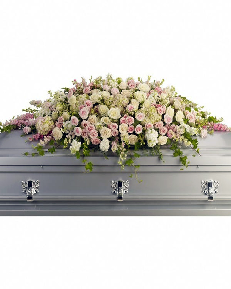 Peaceful Eternal Casket Spray Standard Pink hydrangea, larkspur and roses mingle with white roses, stock and waxflower. Ivy, fern and fragrant eucalyptus act as green accents in this spray that rests atop the casket. Approximately 66