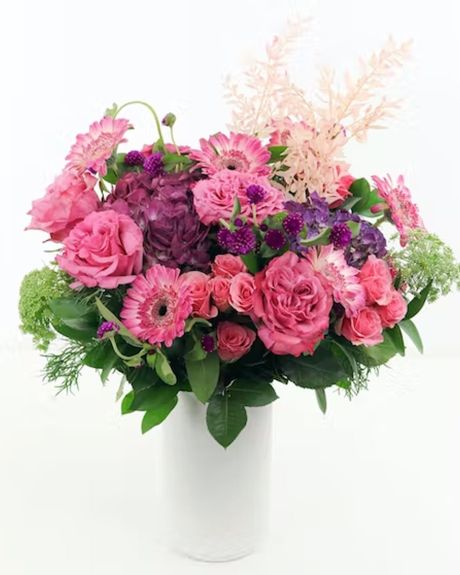 Pretty in Pink-Rich purple Hydrangea, South American pink Garden Roses, pink mini Gerbera Daisies, and loads of texture, including some light-pink dried florals all combine in this gorgeous arrangement. Floral arrangement


