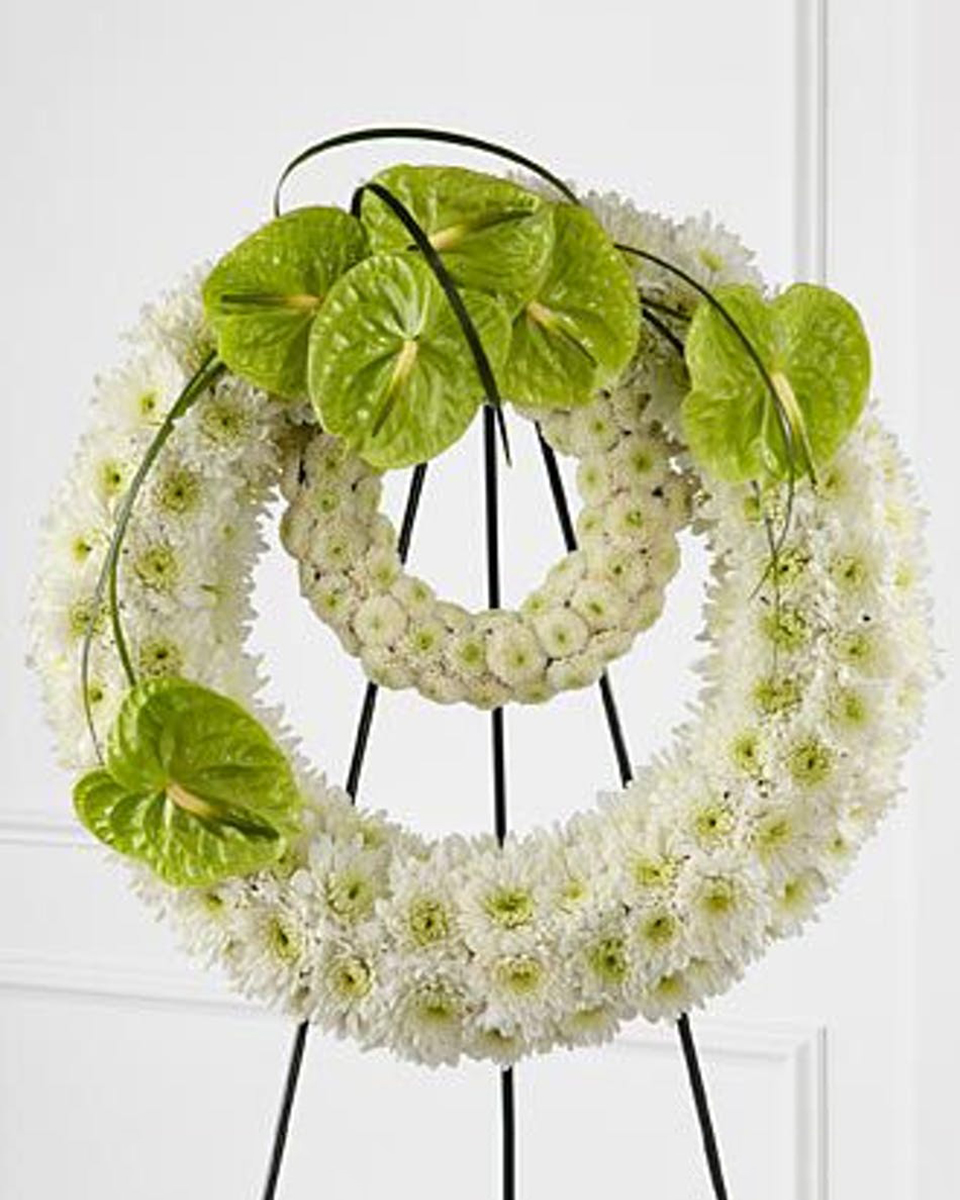 Rings of Earth Deluxe (24 Inch) A Standing Double Wreath on an Easel. The Outer Ring consists of White Cushion Poms with a Green Anthurium Spray at the top. The Inside Ring consists of White Button Poms. Bear Grass accentuates the Spray Of Anthuriums.
DELIVERY: Every order is hand-delivered direct to the recipient. These items will be delivered by us locally, or a qualified retail local florist.