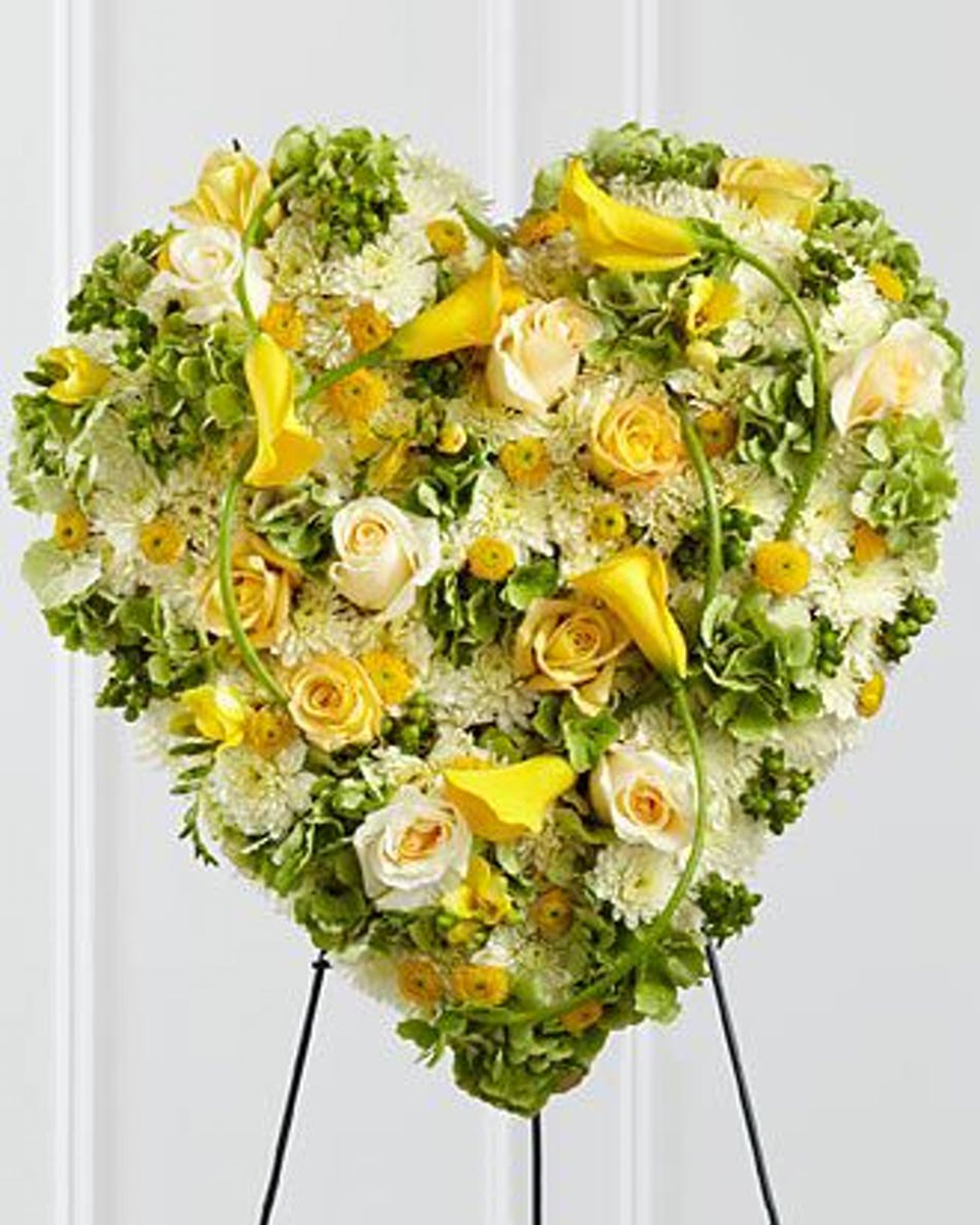 Heart of Gold Deluxe (24 Inch) Yellow and White Roses, White Cushion Pom Poms, Yellow Dot Poms, and assorted Greens comprise this solid Heart standing on an easel.
DELIVERY: Every order is hand-delivered direct to the recipient. These items will be delivered by us locally, or a qualified retail local florist.