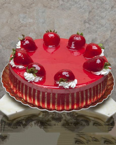 Strawberry Mousse cake-A thin layer of cake surrounds Rich, Luscious, Strawberry Mousse which is Glazed, and then topped with whole Strawberries. Cake