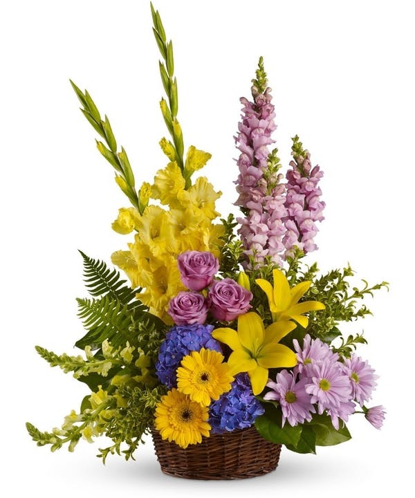 Sympathy Garden Basket Standard Beautiful flowers such as blue hydrangea, lavender roses, snapdragons and daisy spray chrysanthemums along with yellow asiatic lilies, gerberas, gladioli, snapdragons and brilliant greenery are delivered in a lovely wicker basket. Standard Version approximately 23 1/2