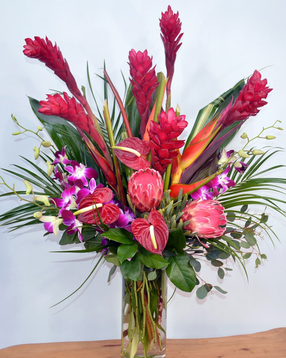 Trade Winds Deluxe An exotic paradise of tropical flowers and foliage are elegantly arranged in a vase.  
 
DELIVERY: Every order is hand-delivered direct to the recipient. This item is only deliverable to local areas serviced by Allen’s Flower Market Stores. 