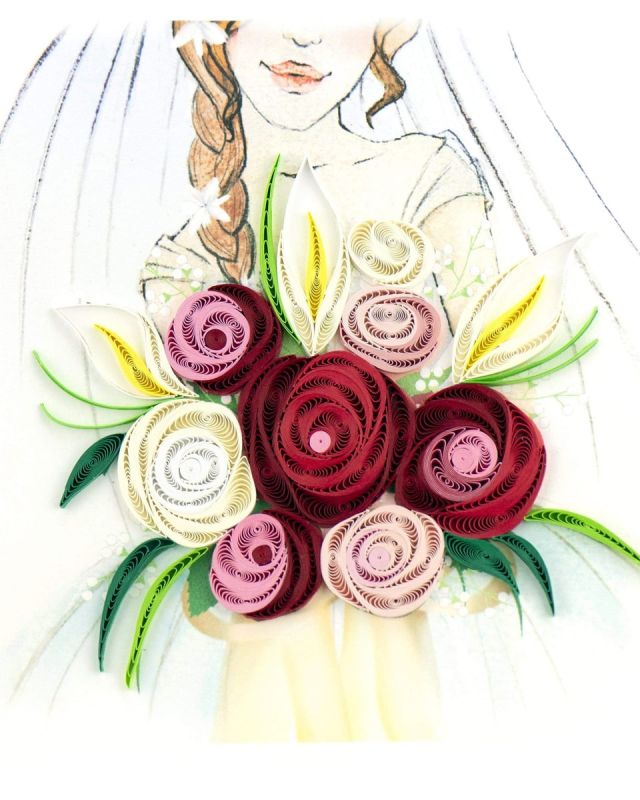 Quilling Bridal Bouquet Card Congratulate the bride on her special day with a one-of-a-kind quilled Wedding Bouquet Card. This card is sure to be cherished for years to come and will remind the bride of their special day. The paper art design features a wedding bouquet of red and pink roses with white Lillies held by a bride that is printed in the background. Don’t just send a card, send art!Certified Fair Trade Federation Member