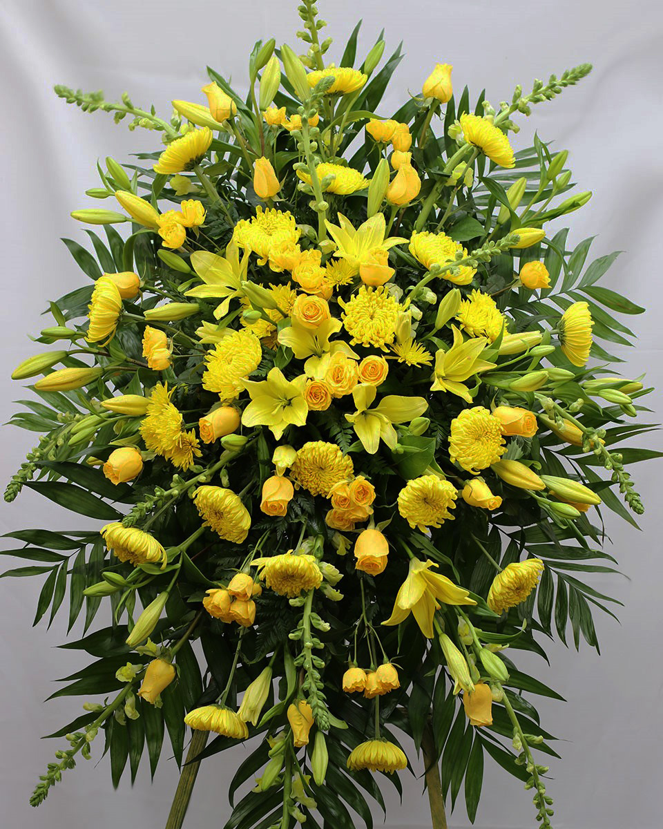 The Yellow Swan Deluxe Send your sincere condolences with our all-yellow standing spray. Crafted on a striking easel using the freshest available yellow roses, mums, snapdragons, lilies and more... Traditionally sent directly to the funeral home by family members or friends.
DELIVERY: Every order is hand-delivered direct to the recipient. These items will be delivered by us locally, or a qualified retail local florist.