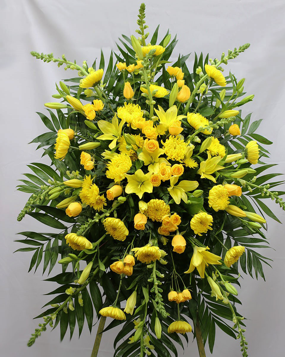 The Yellow Swan Standard Send your sincere condolences with our all-yellow standing spray. Crafted on a striking easel using the freshest available yellow roses, mums, snapdragons, lilies and more... Traditionally sent directly to the funeral home by family members or friends.
DELIVERY: Every order is hand-delivered direct to the recipient. These items will be delivered by us locally, or a qualified retail local florist.