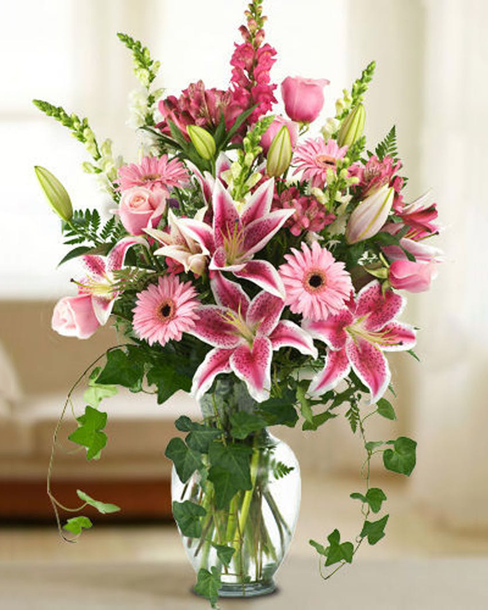 Gracefully Elegant Standard Stir up your sweetheart's emotions by sending this spectacular arrangement of gerbera daisies, lilies, roses, alstroemeria, and snapdragons in shades of pink, complimented with gorgeous greenery. PLEASE NOTE: Due to the popularity of these flowers, colors may vary. We will ensure the substitutions meet the value of this stunning selection.
DELIVERY: Every order is hand-delivered direct to the recipient. These items will be delivered by us locally, or a qualified retail local florist.